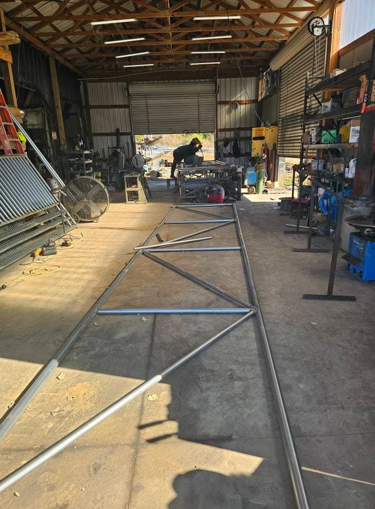 A Sands Fence Co. welder fabricating steel gate frames inside the company shop
